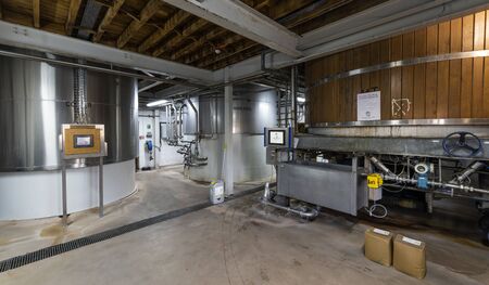 Ringwood, England - October 26, 2018: Production of beer at the Ringwood Brewery with stainless steel barrels and pipes.のeditorial素材