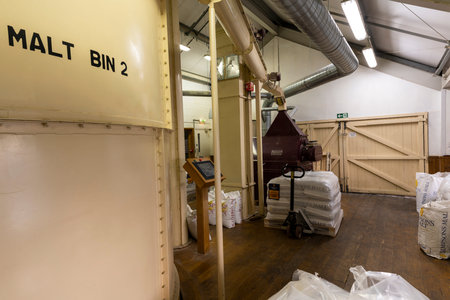 Ringwood, England - October 26, 2018: Production of beer at the Ringwood Brewery with malt barrels,...