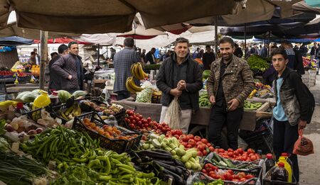 Dogubeyazit, Turkey - May 10, 2019: Three man on the market of Dogubeyazit, with lots of fruit and vegetables, Turkeyのeditorial素材