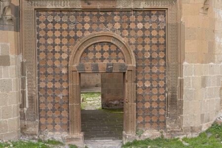 Ani, Turkey - May 9, 2019: Ruins of the old Armenian town Ani with decorated palace entrence, Turkey.のeditorial素材