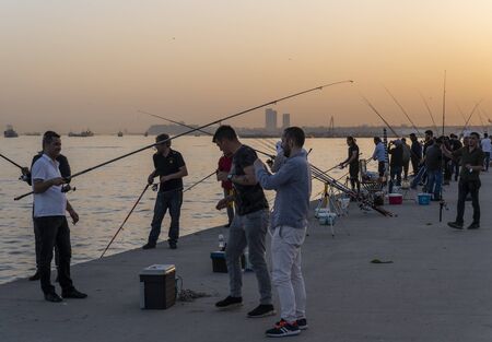 Istanbul, Turkey - April 29, 2019: Fishing men at the bloulevard at the harbor in Instanbul, Turkey.のeditorial素材