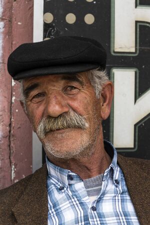 Susuz, Turkey - May 9, 2019: Turkish man with hat, moustache and beard in a turkish cafe.のeditorial素材