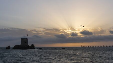 ar, Turkey - May 7, 2019: Sunset at the Black Sea at Pazar, Rize, with castle Kiz sun rays and orange sky.のeditorial素材
