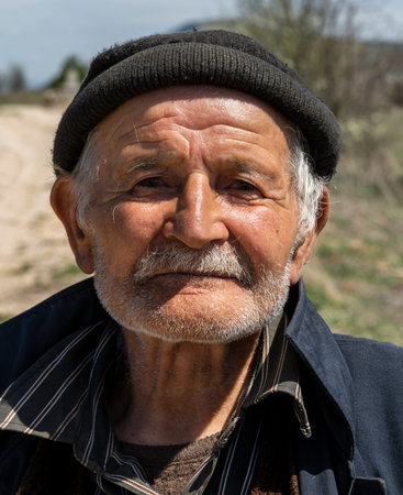 Deresoplan, Turkey - May 1, 2019: Old, characteristic turkish man with black cap and moustache.