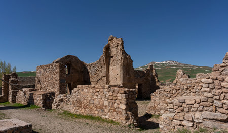 Historical Takht-e Soleyman with hills and snowy mountains in Iran.