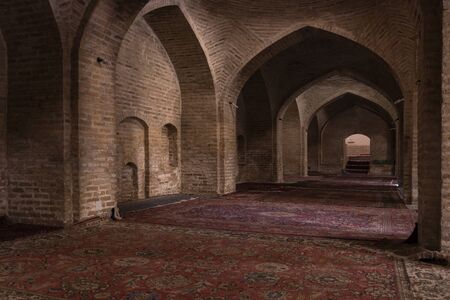 Damghan, Iran - May 25, 2019: Interior of the Jameh Mosque wit carpet and great walls in Damghan, Iran.のeditorial素材