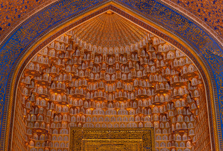 Samarqand, Uzbekistan - June 9, 2019: Ceiling with gold and blue colors of the Tillya-Kori Madrasah...