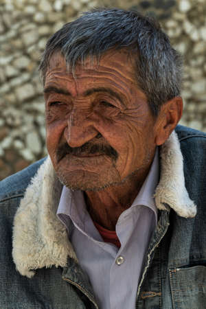 Ishkoshim, Tajikistan - June 20, 2019: Portait of an old man with mustache in the Wakhan Valley at the Pamir Highway in Tajikistan.のeditorial素材