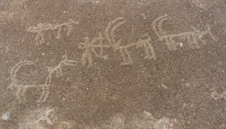 Old petroglyphes of hunters and Ibex at Langar on rock and mountain in the Wakhan Corridor in...