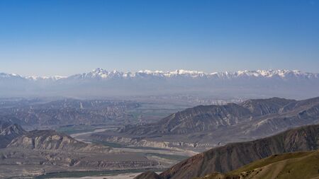 Panorama of the Toguz Toro Pass with valley Kyrgyzstan on a summers day with blue sky and mountains with snow.の写真素材