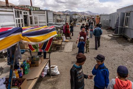 Murghab, Tajikistan - June 25, 2019: The market with container shops and  people in Murghab,...
