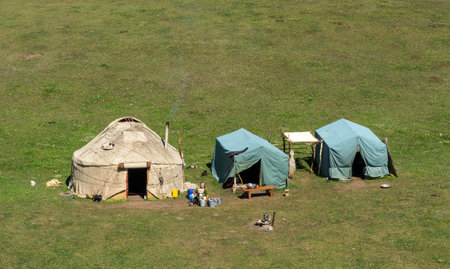 Toguz Toro, Kyrgyzstan - July 5, 2019:  Yurts with tents and man at the Toguz Toro Pass at the silk road in Kyrgyzstan.のeditorial素材