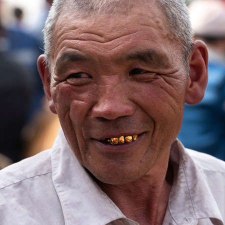 Osh, Kyrgyzstan - June 30, 2019: Man with golden teeth on the livestock market in Osh, Kyrgyzstan.のeditorial素材