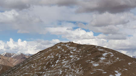 Ak-Baital, Tajikistan - June 26, 2019:  Hiker on mountain at the Ak-Baital pass with view on snowy high mountains and valley.のeditorial素材
