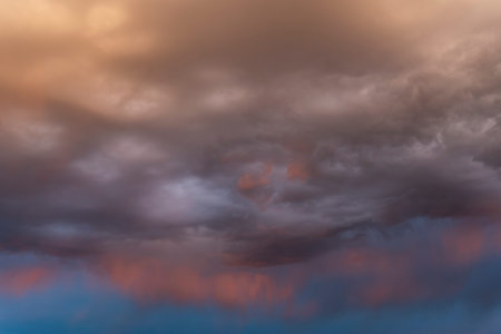 Dark black colorful sky with rain during sunset.