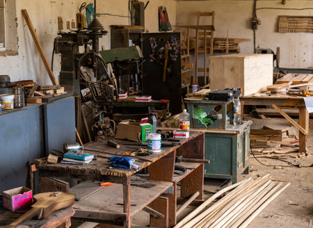 Barskon, Kyrgyzstan - July 10, 2019: Table with tools, wood  and  machines in a yurt (ger) factory...