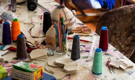 Barskon, Kyrgyzstan - July 10, 2019: Table with tools, spools of thread and  felt in a yurt (ger)...