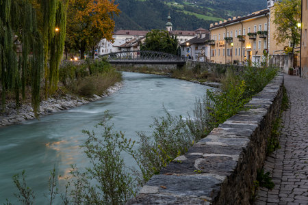 Brixen, Italy - October 9, 2020: City centre of Brixen at night with the river Eisack, Isarco, church and bridge.のeditorial素材