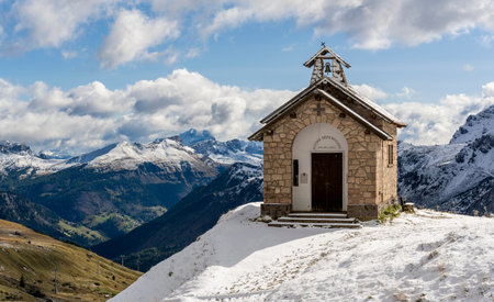 Bordoi Belluno, Italy - October 7, 2020: Chapel of Santa Maria Della Difesa in the snow on the pass of Bordoi Belluno in Trentino Alto Adige in the Dolomites in Italy.のeditorial素材