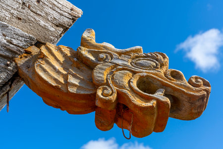Yello, wooden dragon on small, old Buddhist temple in the steppe of Mongolia, in Burenhaan.の写真素材