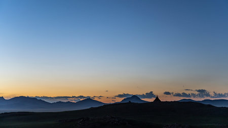 Ovoo on top of a hill at night wit clear sky in the steppe of Mongolia, a sacred place in Buddhism.