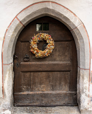 Autumn wreath with dreid flowers on an old wooden door.