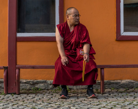 Ulaanbaatar, Mongolia - August 25, 2019: Gandantegchinlen Monastery in Ulaanbaatar with a monk...