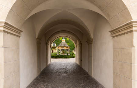 Brixen, Italy - October 9, 2020: Gate with garden and arbor in the monastery of Abbazia di Novacella, Kloster Neustift in autumn in the Dolomites, Italy.のeditorial素材