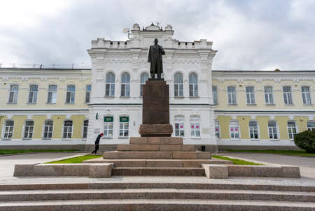 Omsk, Russia - September 13, 2019: Statue of communist Lenin in the city of Omsk in front of a large building.のeditorial素材