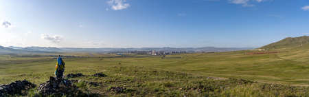 Panorama of Ulaanbaatar with green steppe and ovoo in the forground.の写真素材