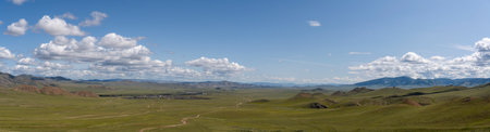 Panorama of the town of Dzagasata Dugan in the mongolian steppe with hills and mountains in the summertime.の写真素材