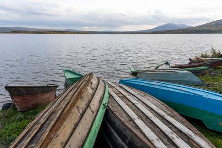 Green rowing boats with water and in the water on lake Ozero Zyuratkul in Siberia, Russia.の写真素材
