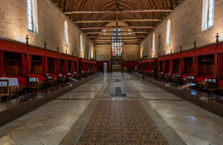 Buaune, France - July 2, 2020: Interior with beds and red blankets of hospice and museum l'Hotel-Dieu, in Beaune, Franceのeditorial素材