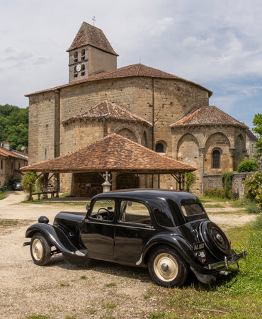 Saint-Jean-de-Cole, France - June 12, 2022: Church and car, Citroen Traction Avant, in the village of Saint-Jean-de-Cole one of the 'Plus beaux village de France'.のeditorial素材