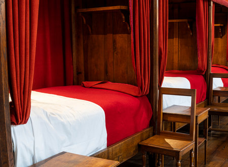 Buaune, France - July 2, 2020: Interior with beds and red blankets of hospice and museum l'Hotel-Dieu, in Beaune, Franceのeditorial素材