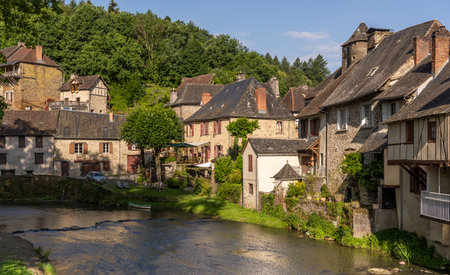 Segur-le-Chateau, France - June13, 2022: The river L'Auvezere and old houses in the village of Segur-le-Chateau one of the 'Les Plus Beaux Villages de France'.のeditorial素材