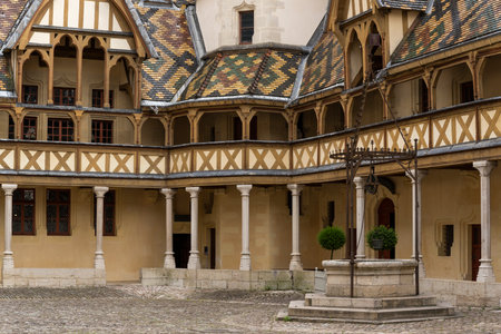 Buaune, France - July 2, 2020: Hospice and museum l'Hotel-Dieu, Hospice the Beaune with courtyard and colered roofs with tilesのeditorial素材