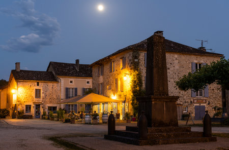 Saint-Jean-de-Cole, France - June 12, 2022: Terrace and restaurant with people at night in the village of Saint-Jean-de-Cole one of the 'Plus beaux village de France'.のeditorial素材