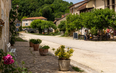 Saint-Jean-de-Cole, France - June 12, 2022: Quiet street with flowers and terrace in the village of Saint-Jean-de-Cole one of the 'Plus beaux village de France'.のeditorial素材