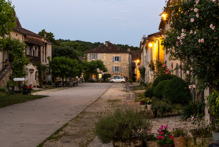 Saint-Jean-de-Cole, France - June 12, 2022: Quiet street with flowers and terrace in the evening in the village of Saint-Jean-de-Cole one of the 'Plus beaux village de France'.のeditorial素材