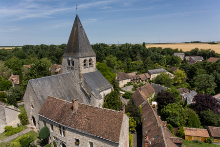 Yevre-le-Chatel, France - June 15, 2022: Small village with church of Yevre-le-Chatel, one of the 'Plus Beaux Villages de France', view from the fortress.のeditorial素材