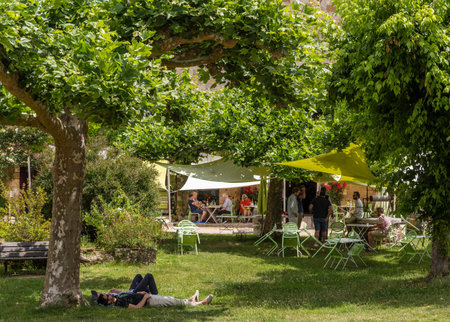 Saint-Jean-de-Cole, France - June 12, 2022: Terrace and restaurant with people in the village of Saint-Jean-de-Cole one of the 'Plus beaux village de France'.のeditorial素材