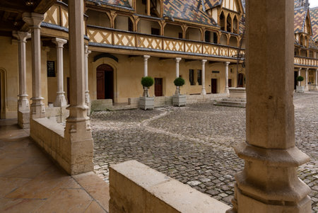 Buaune, France - July 2, 2020: Hospice and museum l'Hotel-Dieu, Hospice the Beaune with courtyard and colered roofs with tilesのeditorial素材