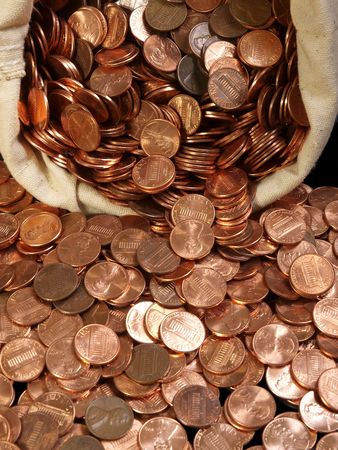New pennies spilling out of a vintage canvas coin bag.      の写真素材