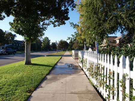 Picket fence on a pretty middle class street.  の写真素材