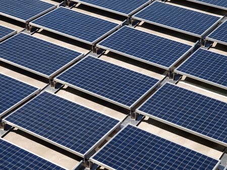 Photovoltaic solar panels on a concrete rooftop.     の写真素材