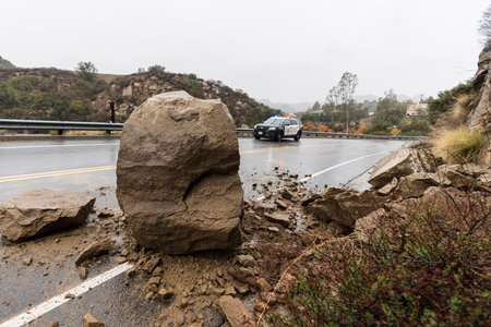 Los Angeles, California, USA - December 30, 2021:  Los Angeles Police car responding to rain storm rockslide blocking traffic lane on Santa Susana Pass Road in Chatsworth.のeditorial素材