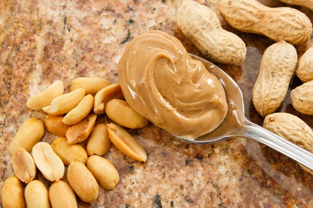 A spoonful of creamy peanut butter is a healthy food and a dangerous allergenの写真素材