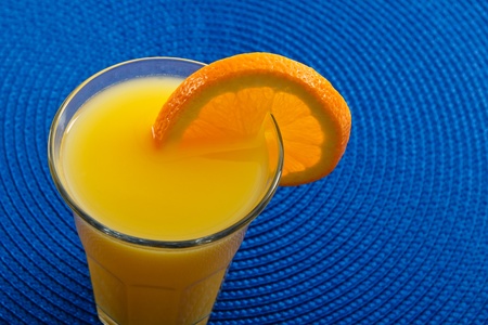 Sunny yellow fresh natural orange juice is full of Vitamin C and Potassium making it a healthy beverage and a great choice for breakfast in the morning.の写真素材