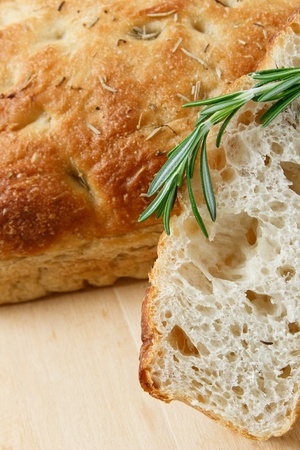 Close up of sliced rosemary focaccia with a sprig of rosemaryの写真素材